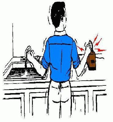 Man with one hand in sink and other on electrical device