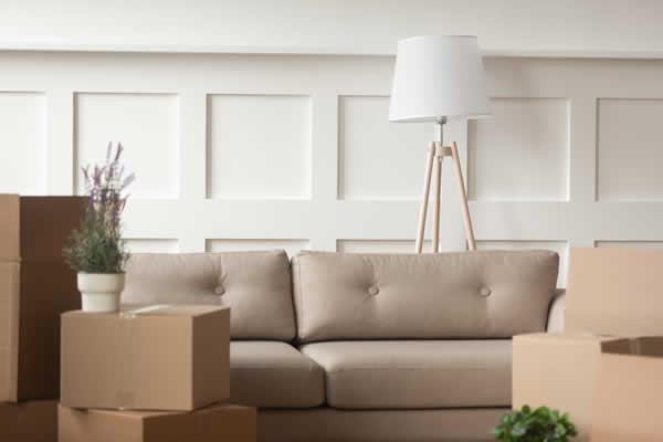 sofa in room with moving boxes